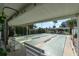 Covered shuffleboard courts with benches and lush landscaping in the background at 7560 Bay Island S Dr # 144, South Pasadena, FL 33707