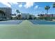 Well-maintained blue and green tennis courts surrounded by palm trees at 7560 Bay Island S Dr # 144, South Pasadena, FL 33707