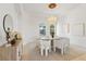 Bright dining room featuring an elegant chandelier, arched windows, and a modern table with seating for six at 903 Symphony Beach Ln, Apollo Beach, FL 33572