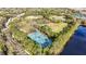 Scenic aerial view featuring tennis courts surrounded by lush greenery at 9481 Highland Oak Dr # 1410, Tampa, FL 33647