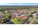 Overhead view of the residential community boasting red-roofed condos nestled amongst green trees and a serene lake at 9481 Highland Oak Dr # 1410, Tampa, FL 33647