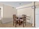 Cozy dining space with a round table set, complemented by tiled flooring, next to the fridge at 9481 Highland Oak Dr # 1410, Tampa, FL 33647
