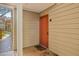 Front entrance to the unit showcasing a warm-toned exterior, welcome mat and unit number at 9481 Highland Oak Dr # 1410, Tampa, FL 33647