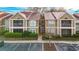 Inviting two-story condo featuring a well-maintained lawn, screened porches, and designated parking spaces at 9481 Highland Oak Dr # 1410, Tampa, FL 33647