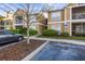 The charming condo building offers accessible parking, with manicured shrubs lining the sidewalk at 9481 Highland Oak Dr # 1410, Tampa, FL 33647