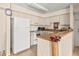 Bright kitchen features white appliances, neutral countertops, and a backsplash; perfect for everyday cooking at 9481 Highland Oak Dr # 1410, Tampa, FL 33647