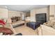 Comfortable living room with tile flooring and view into dining area and kitchen at 9481 Highland Oak Dr # 1410, Tampa, FL 33647