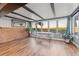 Dining room with brick accent wall and large windows that capture the waterfront view at 10516 94Th Pl, Seminole, FL 33772