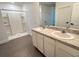 Bathroom showcasing double sinks with a wide vanity, tile flooring and a walk-in shower at 10908 Carlton Fields Dr, Riverview, FL 33579