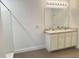 Bathroom featuring double sinks with white cabinets and a large mirror, with a combined shower and tub at 10908 Carlton Fields Dr, Riverview, FL 33579