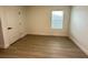 Cozy bedroom with wood-look flooring and a window providing natural light at 10908 Carlton Fields Dr, Riverview, FL 33579