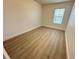 Bedroom with light wood floors, a window with blinds, and neutral walls, offering a bright and airy space at 10908 Carlton Fields Dr, Riverview, FL 33579