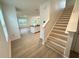 Bright entryway with staircase and view to an open-concept living area with kitchen at 10908 Carlton Fields Dr, Riverview, FL 33579