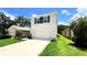 Charming two-story home with neutral stucco, dark shutters, two car garage, and well-manicured landscaping at 10908 Carlton Fields Dr, Riverview, FL 33579