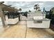 Outdoor grill area featuring a built-in grill, granite countertop, and safety signage, enhancing outdoor cooking at 10908 Carlton Fields Dr, Riverview, FL 33579
