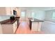 Modern kitchen features a large island with granite countertops, white cabinets, and black appliances at 10908 Carlton Fields Dr, Riverview, FL 33579