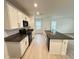 Well-lit kitchen boasts modern appliances, granite countertops, an island, and easy access to the living area at 10908 Carlton Fields Dr, Riverview, FL 33579