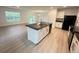 Open-concept kitchen with island, granite countertops, modern appliances, and seamless flow into living space at 10908 Carlton Fields Dr, Riverview, FL 33579