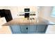 Modern kitchen features a large island with granite countertops, stainless steel sink and black appliances at 10908 Carlton Fields Dr, Riverview, FL 33579