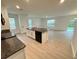 Modern kitchen island featuring a sink, stainless appliances, ample storage, and sleek countertops at 10908 Carlton Fields Dr, Riverview, FL 33579