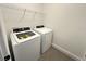 Functional laundry room equipped with a modern washer and dryer set, and convenient overhead shelving at 10908 Carlton Fields Dr, Riverview, FL 33579