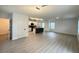Open-concept living space with an island kitchen and wood-look flooring at 10908 Carlton Fields Dr, Riverview, FL 33579