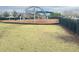 Community playground with a dome climber, slide, and swingset, surrounded by green grass at 10908 Carlton Fields Dr, Riverview, FL 33579