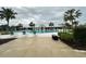 Community pool area with several lounge chairs and lush landscaping, creating a serene environment at 10908 Carlton Fields Dr, Riverview, FL 33579