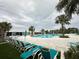 Community pool area offering many lounge chairs and umbrellas for a relaxing experience at 10908 Carlton Fields Dr, Riverview, FL 33579