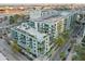 Aerial view of a modern condo building with balconies, palm trees, and rooftop terrace at 111 N 12Th St # 1819, Tampa, FL 33602