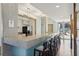 Modern bar featuring stone countertops, seating, and stainless steel appliances at 111 N 12Th St # 1819, Tampa, FL 33602
