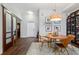 Cozy dining area with a round wood table, stylish chairs, and a unique light fixture at 111 N 12Th St # 1819, Tampa, FL 33602