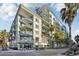 Modern condo building with balconies, palm trees, and street-level shops at 111 N 12Th St # 1819, Tampa, FL 33602