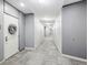 Hallway of condo with doors, grey walls, carpet, and overhead lighting at 111 N 12Th St # 1819, Tampa, FL 33602