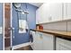 Laundry room featuring new washer and dryer, counterspace and white cabinets with wood floor at 111 N 12Th St # 1819, Tampa, FL 33602