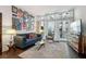 Living room of condo with sofa, armchair, glass coffee table, and decorations on the wall at 111 N 12Th St # 1819, Tampa, FL 33602