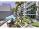 Upscale condo amenities include tables and chairs under large umbrellas in an outside common area at 111 N 12Th St # 1819, Tampa, FL 33602