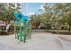 Playground at condo complex featuring blue mushroom water feature, mature trees, and fencing at 111 N 12Th St # 1819, Tampa, FL 33602