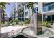 Upscale condo amenities include water fountain surrounded by walkways, tropical landscaping, and modern balconies at 111 N 12Th St # 1819, Tampa, FL 33602