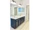 Bathroom featuring dual sink vanity and large mirror at 11566 Balintore Dr, Riverview, FL 33579