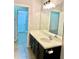 Bathroom features a modern vanity with ample storage and a large well lit mirror at 11566 Balintore Dr, Riverview, FL 33579