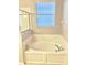 Bright bathroom with soaking tub next to glass shower at 11566 Balintore Dr, Riverview, FL 33579