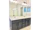 Bathroom featuring dual sink vanity and large mirror at 11566 Balintore Dr, Riverview, FL 33579