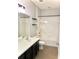 Bathroom featuring a shower and tub combination, modern vanity, and convenient shelving at 11566 Balintore Dr, Riverview, FL 33579