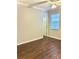 Bedroom featuring hardwood floors, ceiling fan, window and an interior door at 11566 Balintore Dr, Riverview, FL 33579