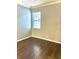 Bedroom features hardwood floors and a window for natural light at 11566 Balintore Dr, Riverview, FL 33579