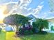 Blue house featuring colorful landscaping and a beautifully maintained lawn at 11566 Balintore Dr, Riverview, FL 33579