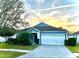 Charming blue home featuring well-manicured landscaping and a two-car garage at 11566 Balintore Dr, Riverview, FL 33579