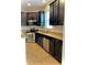 Bright kitchen featuring stainless steel appliances, granite countertops, and dark cabinets at 11566 Balintore Dr, Riverview, FL 33579