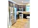 Modern kitchen with stainless steel appliances, dark cabinetry, and granite countertops at 11566 Balintore Dr, Riverview, FL 33579